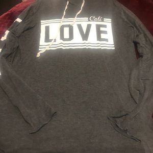 Long sleeve, hoodie. Love printed on the front and down both sleeves.